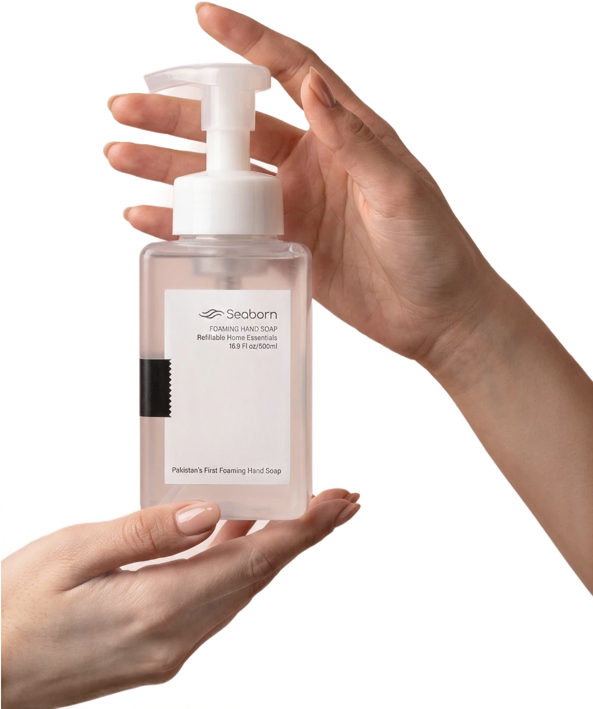 Hands holding a Seaborn foaming hand soap bottle