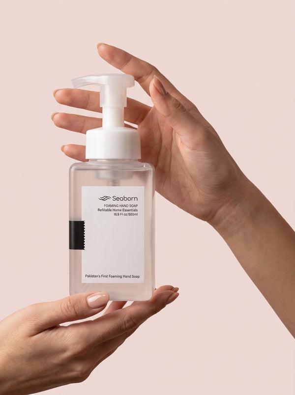 Seaborn refillable foaming hand soap bottle held in two hands