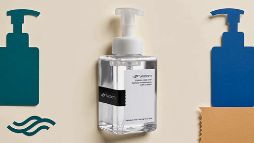 Clear Seaborn foaming bottle with white pump on a cream background